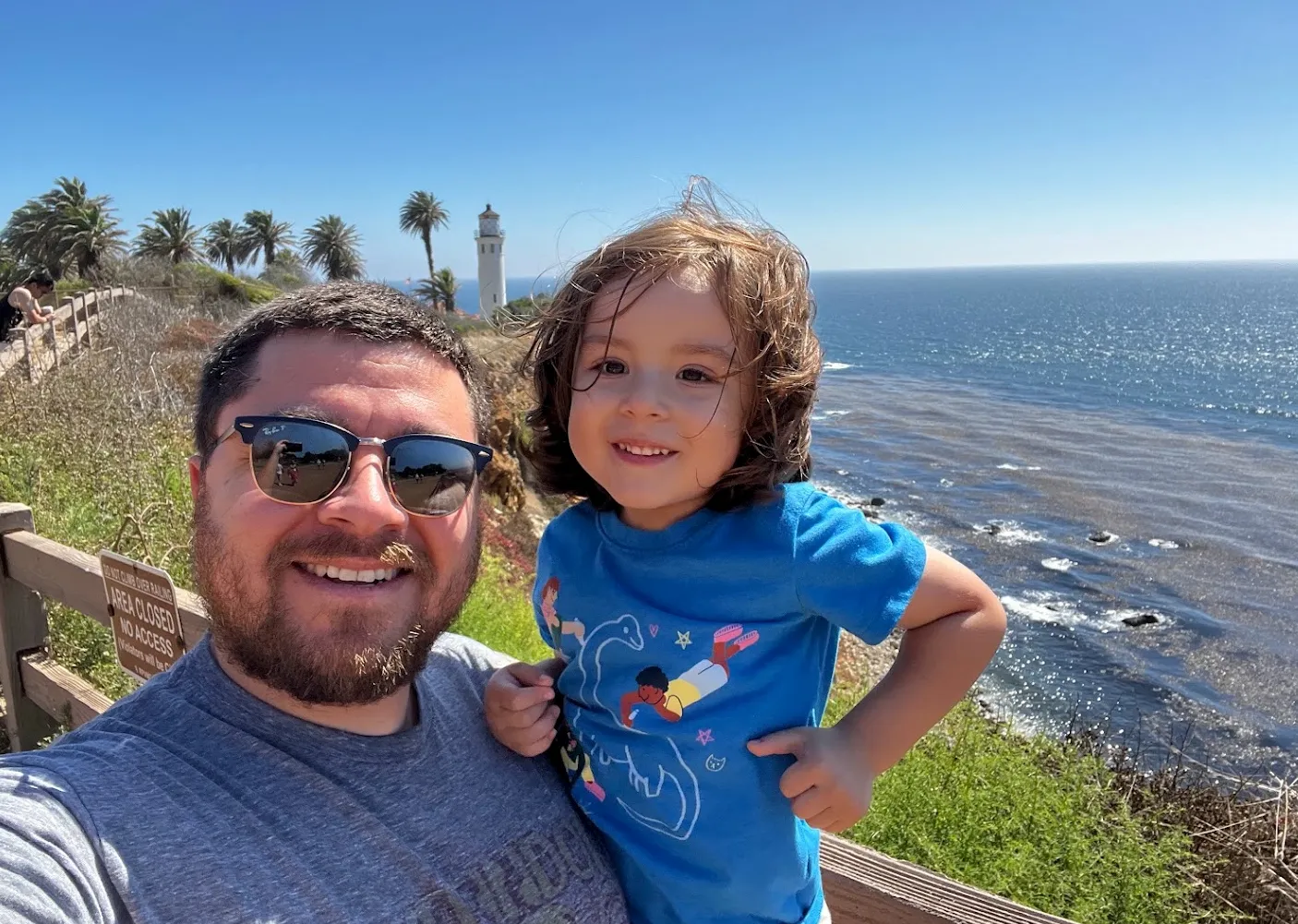 Michael Rios with his child on the California coast